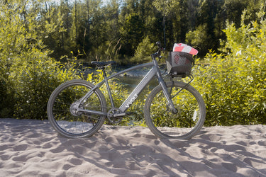 Vvolt Alpha ebike on a beach in Summer with a front basket attached